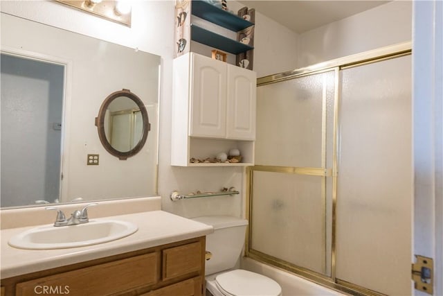 full bathroom featuring enclosed tub / shower combo, vanity, and toilet