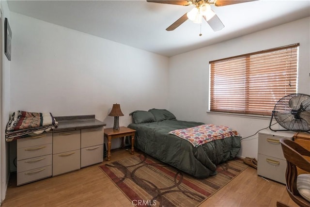 bedroom with ceiling fan and light wood-type flooring