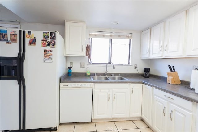 kitchen featuring light tile patterned flooring, white appliances, sink, and white cabinets