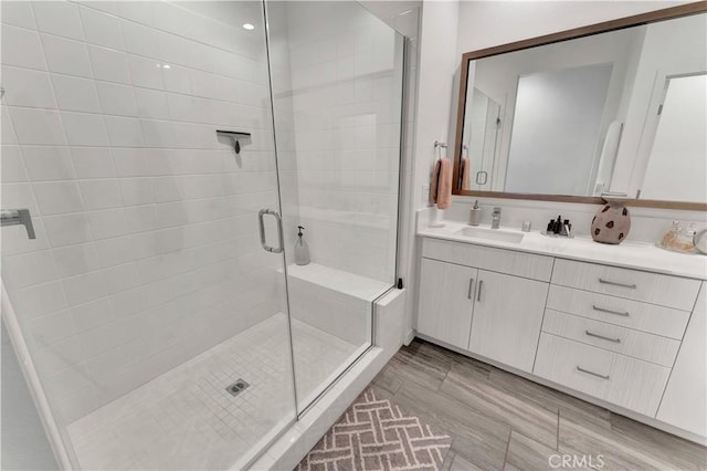 bathroom featuring vanity and a shower with shower door