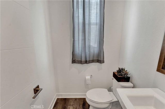 bathroom featuring toilet and hardwood / wood-style flooring