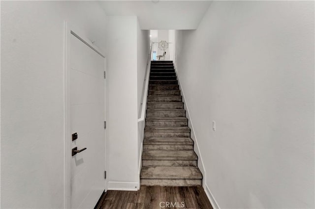 staircase with wood-type flooring