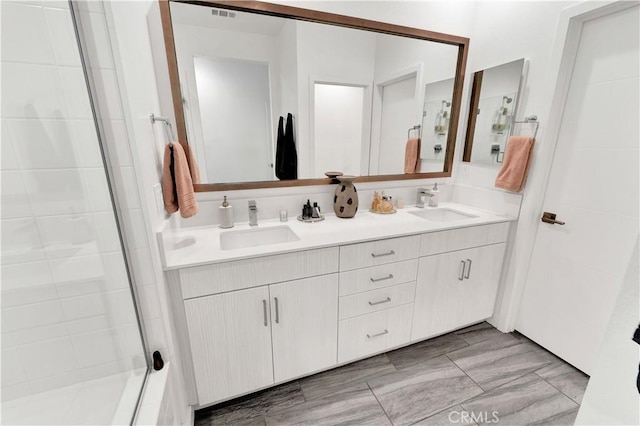 bathroom featuring an enclosed shower and vanity