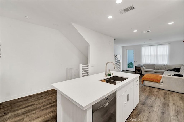 kitchen featuring hardwood / wood-style floors, a kitchen island with sink, white cabinets, black dishwasher, and sink