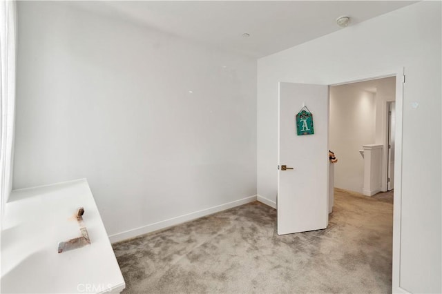 unfurnished bedroom featuring light colored carpet