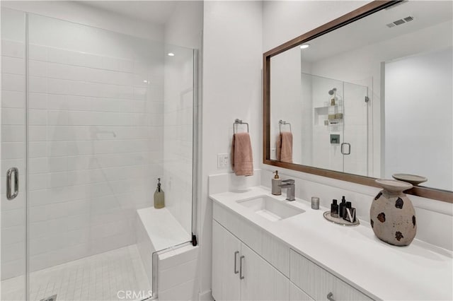 bathroom with walk in shower and vanity