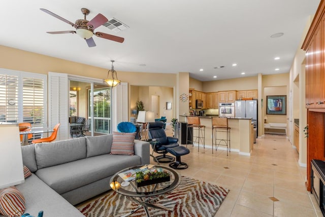 tiled living room featuring ceiling fan