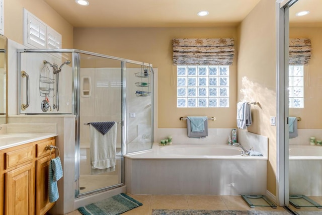 bathroom featuring vanity, separate shower and tub, and tile patterned flooring