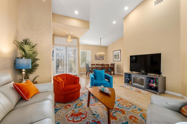 living room featuring vaulted ceiling, a notable chandelier, tile patterned floors, and french doors