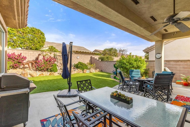 view of patio featuring ceiling fan and a grill