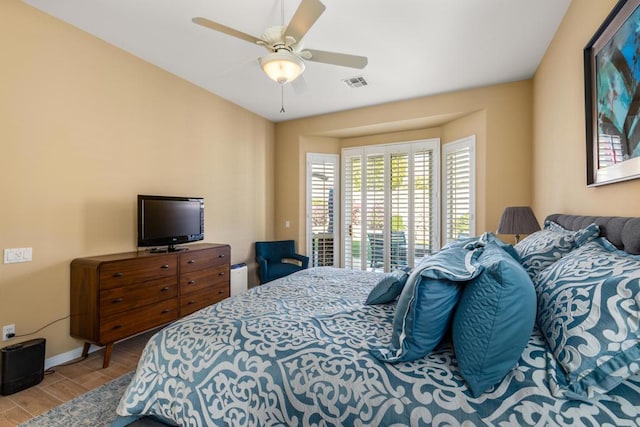 bedroom with ceiling fan and access to exterior