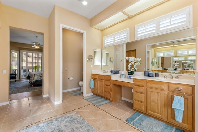 bathroom with ceiling fan, tile patterned floors, vanity, and toilet