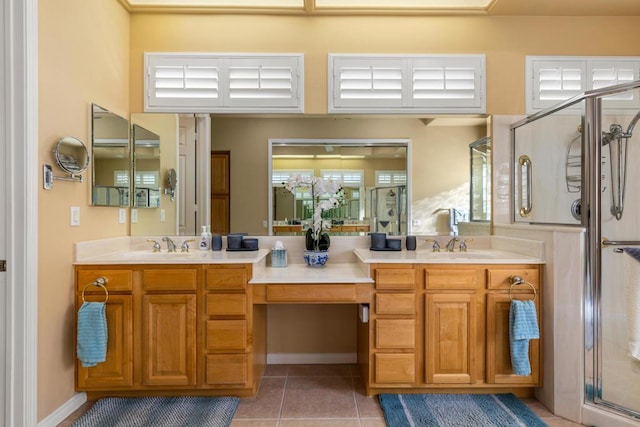 bathroom featuring a shower with shower door, vanity, and tile patterned flooring