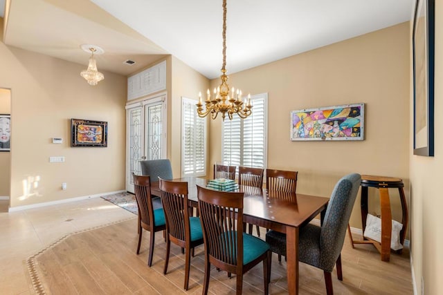 dining room featuring light hardwood / wood-style floors and a notable chandelier