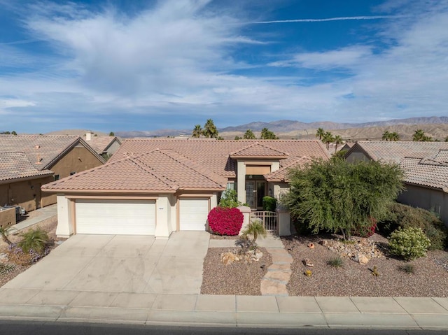 view of front of house featuring a garage and a mountain view