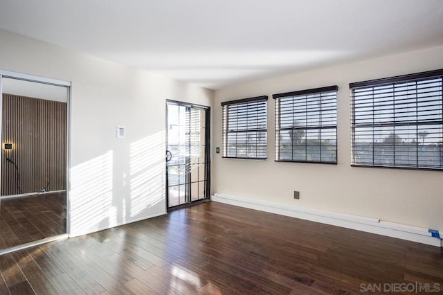 unfurnished room featuring dark hardwood / wood-style flooring