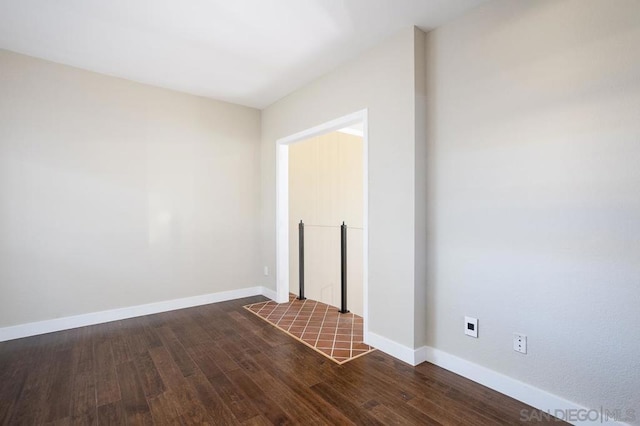 empty room featuring dark wood-type flooring