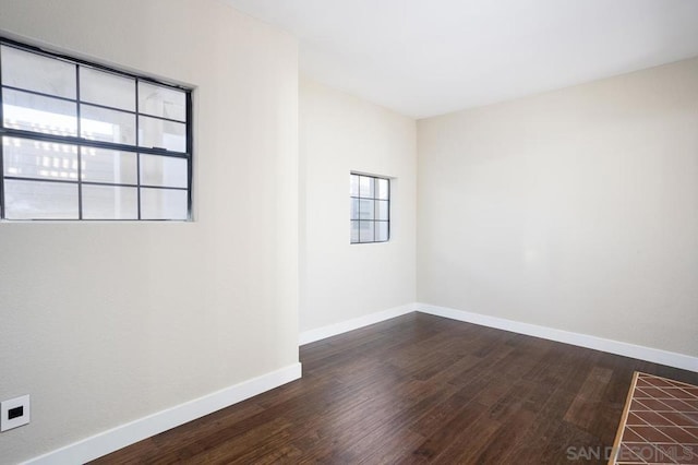 spare room featuring dark hardwood / wood-style flooring