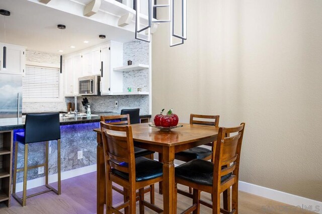 dining space with light hardwood / wood-style flooring