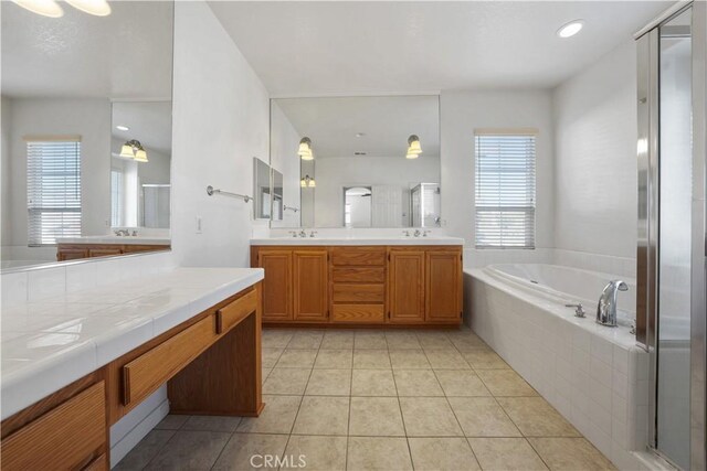 bathroom with separate shower and tub, vanity, and tile patterned flooring