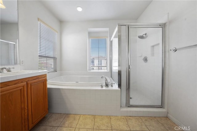 bathroom featuring separate shower and tub, vanity, and a wealth of natural light