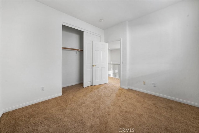 unfurnished bedroom with carpet flooring and a closet