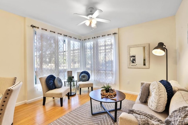 living room featuring hardwood / wood-style flooring and ceiling fan