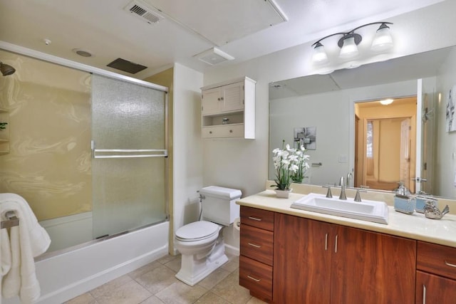 full bathroom with tile patterned flooring, vanity, bath / shower combo with glass door, and toilet