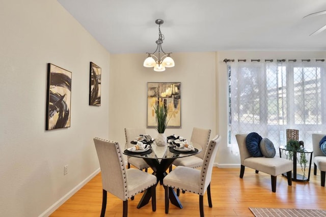 dining room with an inviting chandelier, light hardwood / wood-style flooring, and a healthy amount of sunlight