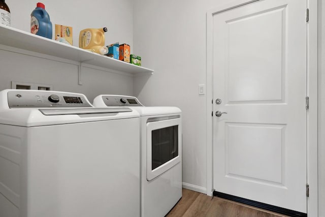 washroom with separate washer and dryer and dark hardwood / wood-style flooring