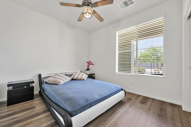 bedroom featuring ceiling fan and dark hardwood / wood-style floors