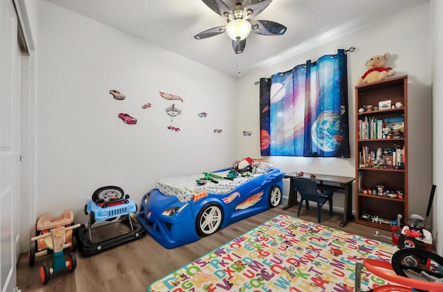 bedroom with ceiling fan and wood-type flooring