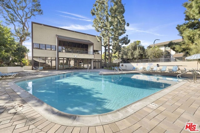 view of swimming pool featuring a patio area