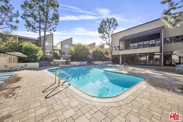 view of pool featuring a patio area