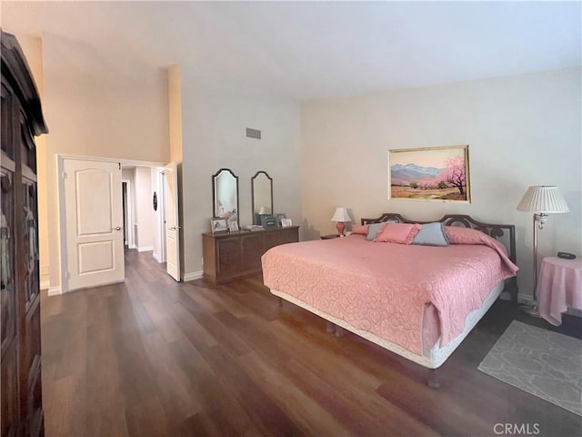 bedroom with dark wood-type flooring