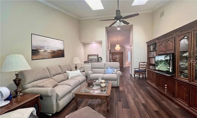 living room featuring ceiling fan, a skylight, dark hardwood / wood-style floors, and crown molding