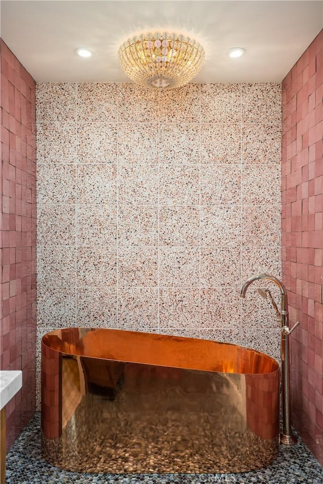 bathroom with tile walls and a bathing tub