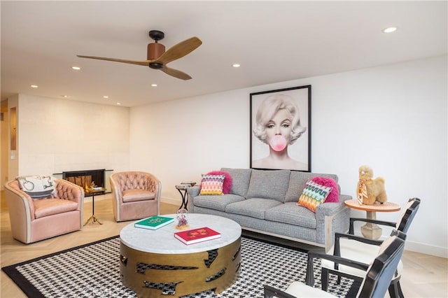 living room featuring light parquet floors, a multi sided fireplace, and ceiling fan