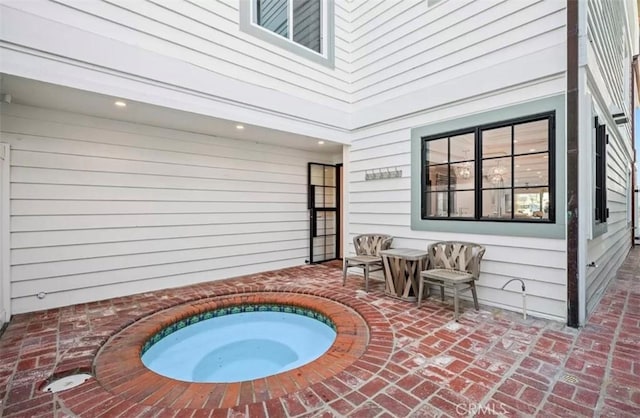 view of patio / terrace featuring an indoor hot tub