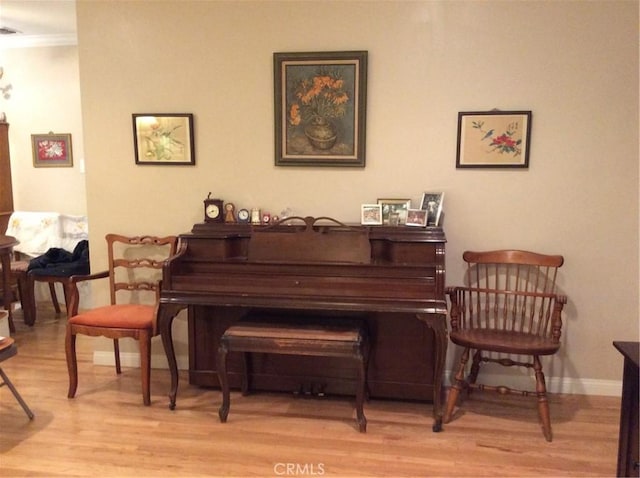 misc room with light wood-type flooring and ornamental molding