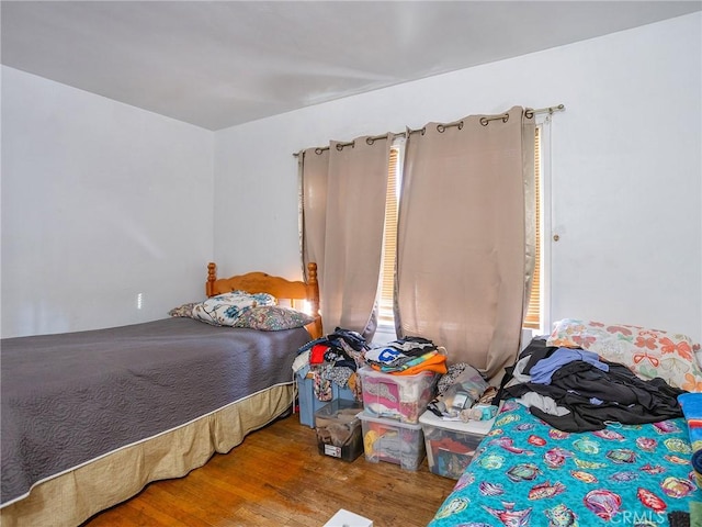 bedroom with hardwood / wood-style floors