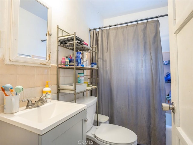 bathroom with decorative backsplash, toilet, and vanity