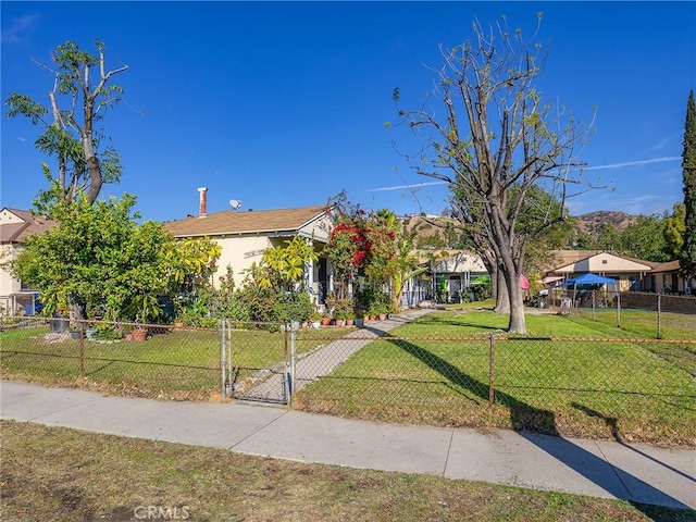 view of property hidden behind natural elements featuring a front lawn