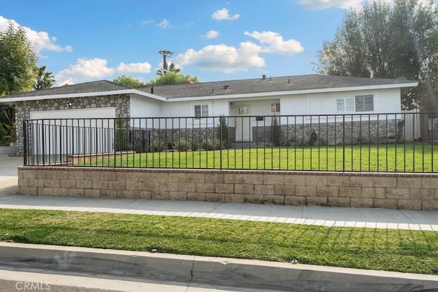 ranch-style home featuring a garage and a front lawn