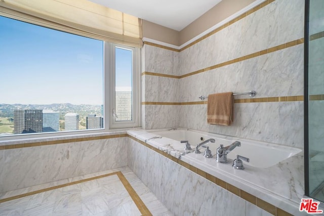 bathroom with tiled bath