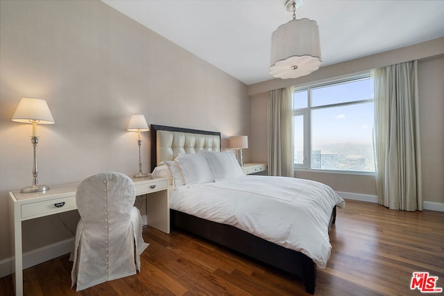 bedroom featuring dark hardwood / wood-style flooring and lofted ceiling