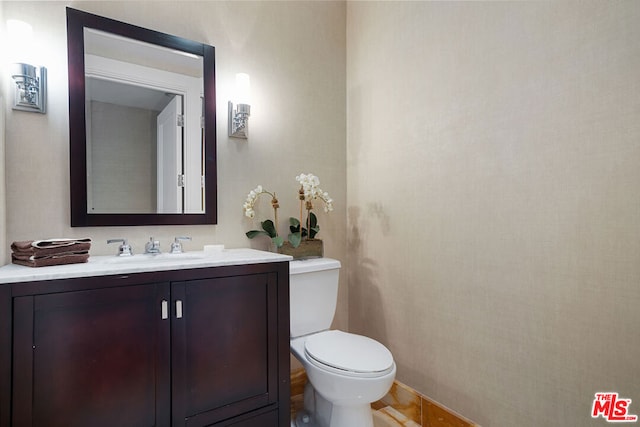 bathroom featuring toilet and vanity