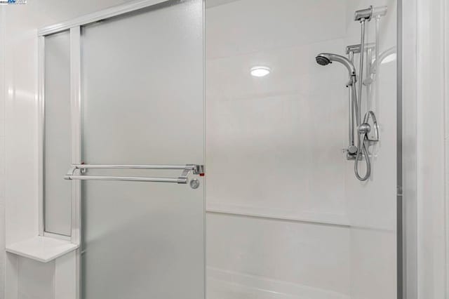 bathroom featuring a shower with door