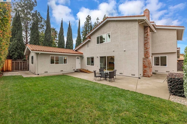 back of house featuring a yard and a patio area