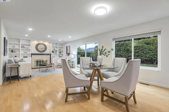 dining area featuring built in features and light wood-type flooring